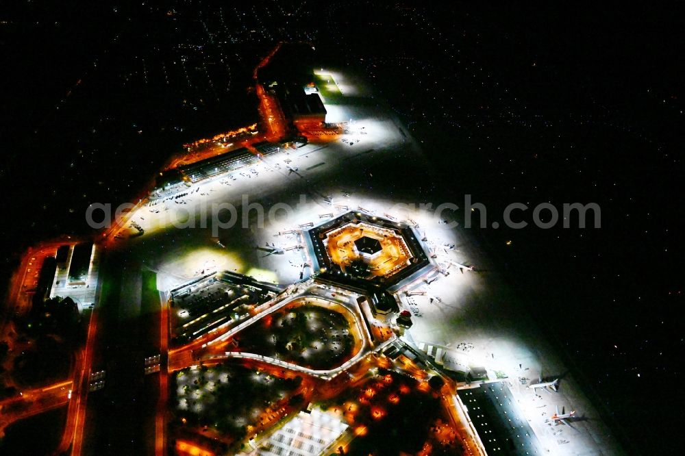 Aerial image at night Berlin - Night lighting flight operations at the terminal of the airport Berlin - Tegel