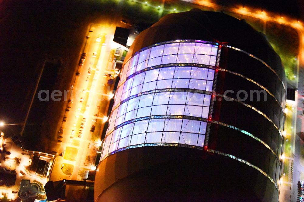 Krausnick at night from above - Night lighting complete complex of the Theme Park Tropical Islands with air hall, outdoor pool, campsite, holiday homes and former airfield on street Tropical-Islands-Allee in Krausnick in the state of Brandenburg, Germany