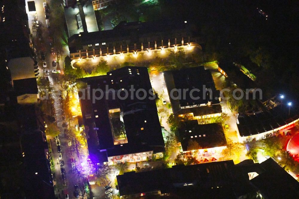 Aerial image at night Berlin - Night lighting leisure Centre - Amusement Park Kinderbauernhof NUSZ - ufaFabrik on Viktoriastrasse in the district Tempelhof in Berlin, Germany