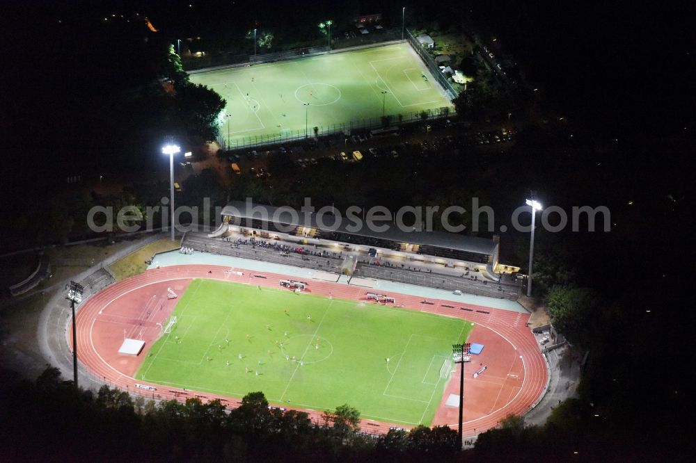 Aerial image at night Berlin - Night lighting football stadium of the football club SSC Sport-Club Charlottenburg e.V. in the district Charlottenburg in Berlin, Germany