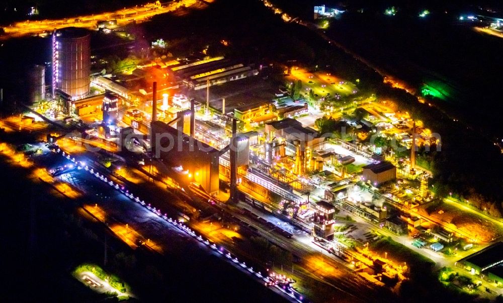 Aerial photograph at night Bottrop - Night lighting gasometer high storage tank at Kokerei Prosper in Bottrop at Ruhrgebiet in the state North Rhine-Westphalia