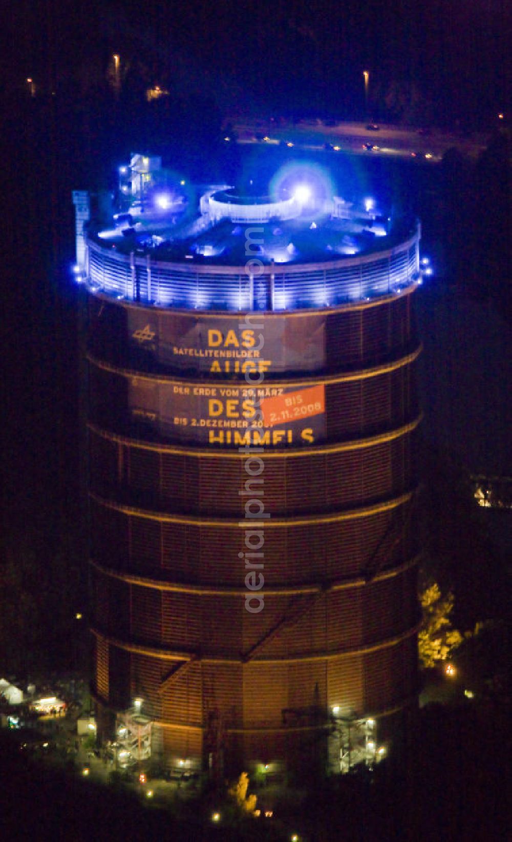 Oberhausen at night from above - Nachtaufnahme: Der Gasometer Oberhausen ist ein Industriedenkmal in der „Neuen Mitte“ Oberhausen / CentrO in Nordrhein-Westfalen. Night shot: The Gasometer Oberhausen is an industrial monument in the new center Oberhausen / Centro in North Rhine-Westphalia.