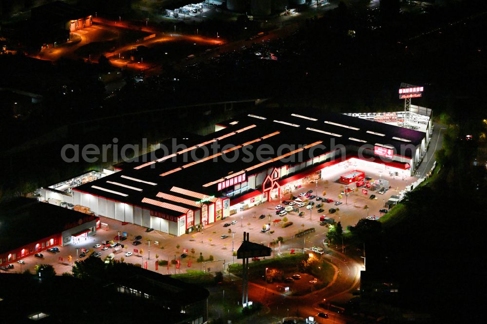 Aerial photograph at night Berlin - Night lighting building of the construction market Bauhaus Berlin-Spandau on street An den Freiheitswiesen in the district Spandau in Berlin, Germany