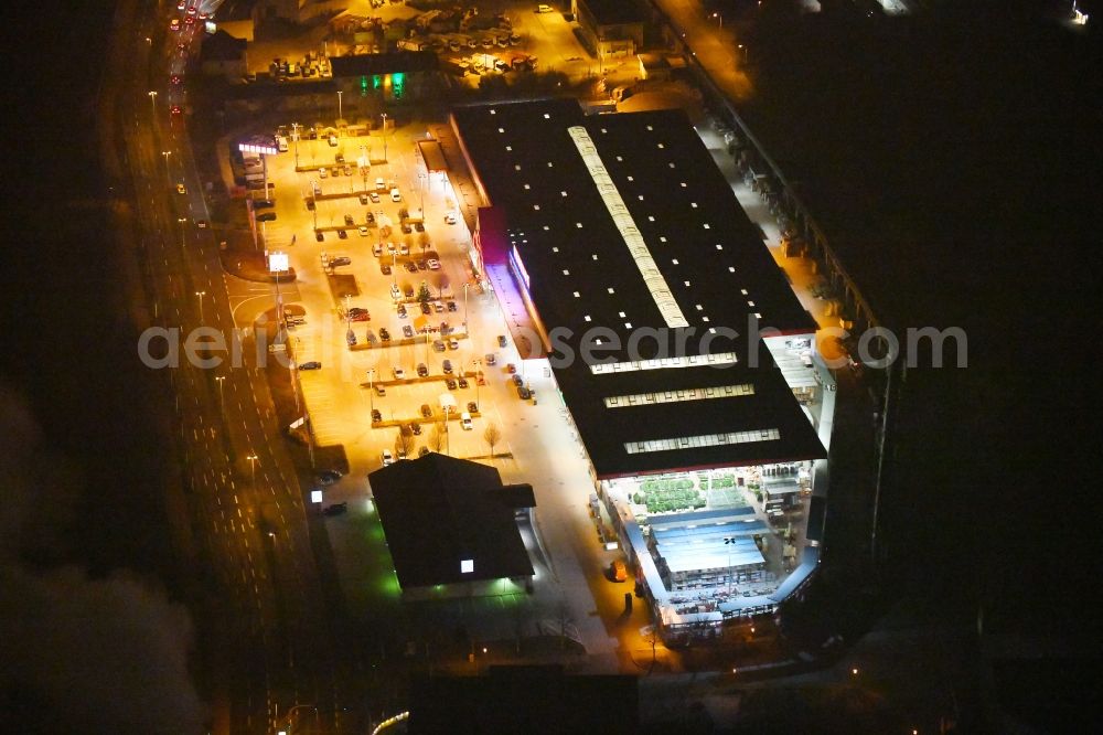 Aerial image at night Gera - Night lighting Building of the construction market BAUHAUS on Elsterdonm in Gera in the state Thuringia, Germany