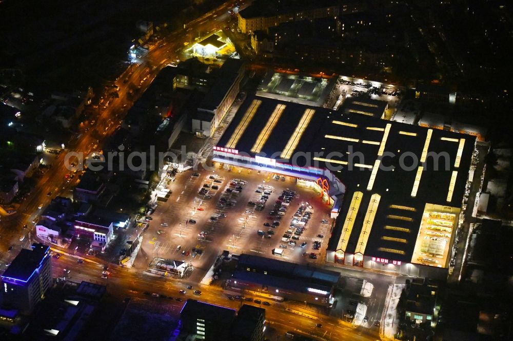 Lübeck at night from the bird perspective: Night lighting building of the construction market BAUHAUS Luebeck Bei of Lohmuehle in Luebeck in the state Schleswig-Holstein, Germany