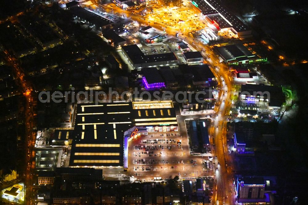 Lübeck at night from the bird perspective: Night lighting building of the construction market BAUHAUS Luebeck Bei of Lohmuehle in Luebeck in the state Schleswig-Holstein, Germany