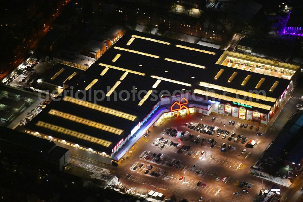 Lübeck at night from the bird perspective: Night lighting building of the construction market BAUHAUS Luebeck Bei of Lohmuehle in Luebeck in the state Schleswig-Holstein, Germany