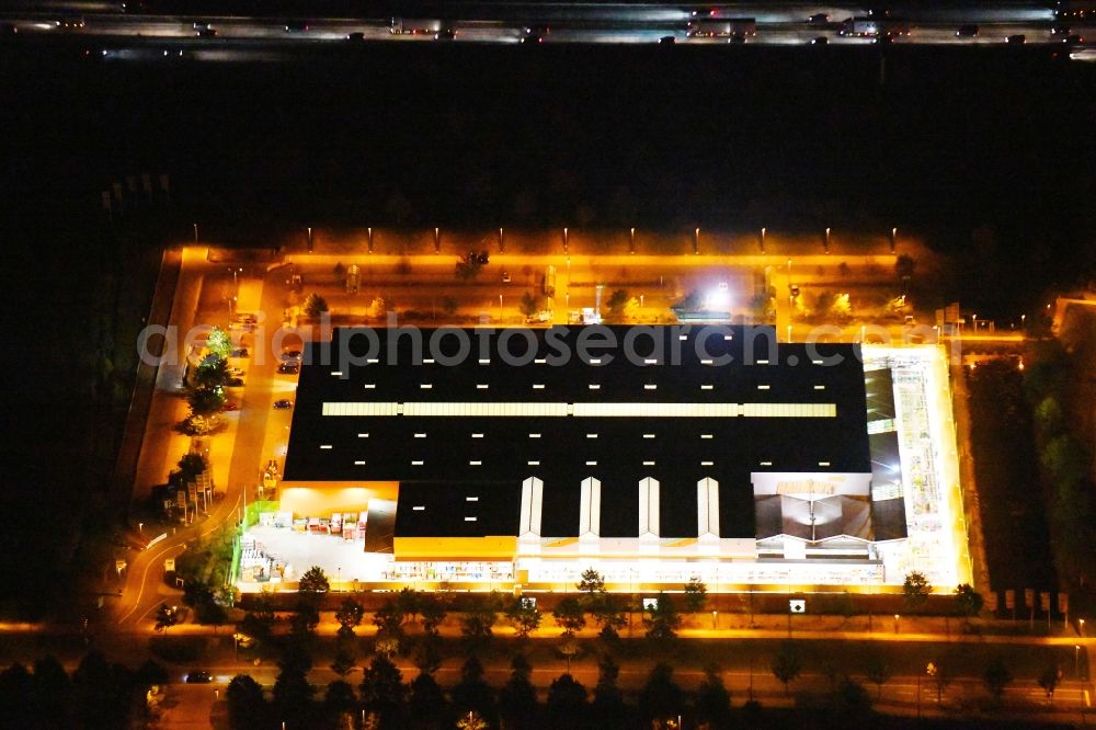 Aerial image at night Dresden - Night lighting building of the construction market Globus Baumarkt Dresden on Raehnitzer Allee in the district Hellerau in Dresden in the state Saxony, Germany