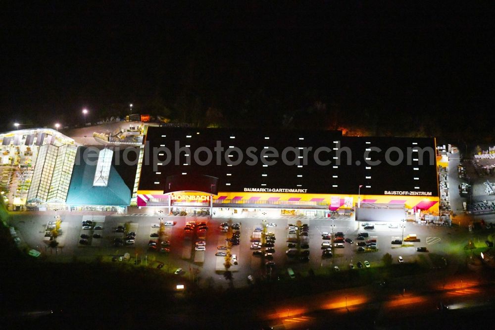 Ludwigsfelde at night from above - Night lighting Building of the construction market of Hornbach Ludwigsfelde on Parkallee in the district Genshagen in Ludwigsfelde in the state Brandenburg, Germany