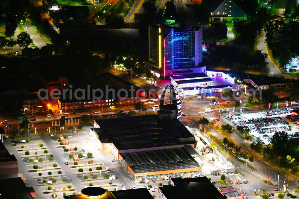 Aerial image at night Berlin - Night lighting building of the construction market OBI on street Nonnendammallee in the district Siemensstadt in Berlin, Germany