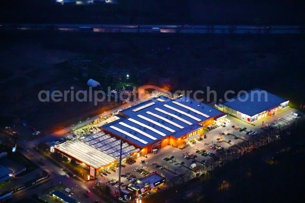 Aerial photograph at night Bernau - Night lighting building of the construction market OBI on J.-F.-A Johann-Friedrich-A.-Borsig-Strasse in Bernau in the state Brandenburg, Germany