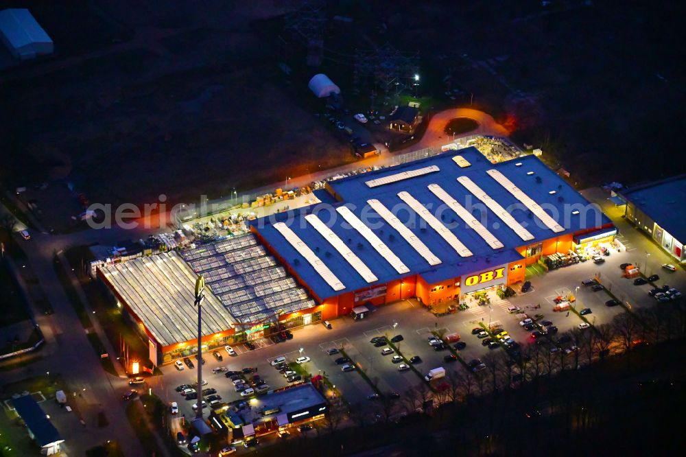 Aerial image at night Bernau - Night lighting building of the construction market OBI on J.-F.-A Johann-Friedrich-A.-Borsig-Strasse in Bernau in the state Brandenburg, Germany