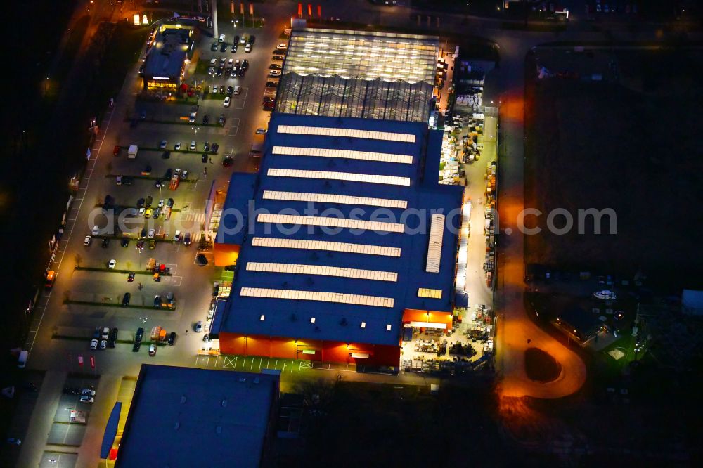 Aerial image at night Bernau - Night lighting building of the construction market OBI on J.-F.-A Johann-Friedrich-A.-Borsig-Strasse in Bernau in the state Brandenburg, Germany