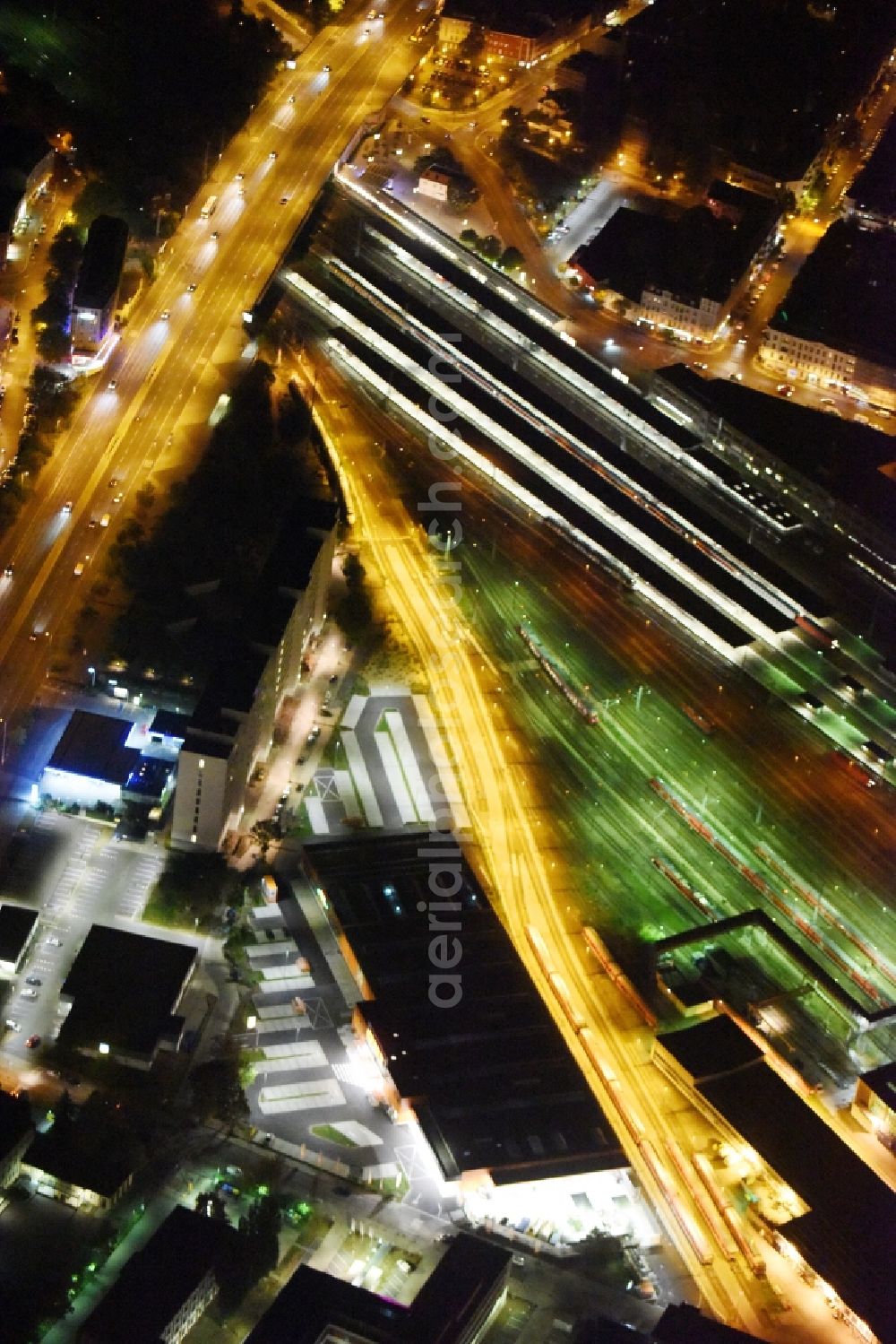 Aerial photograph at night Berlin - Night view building of the construction market of OBI Markt Berlin-Lichtenberg on Buchberger Str in Berlin