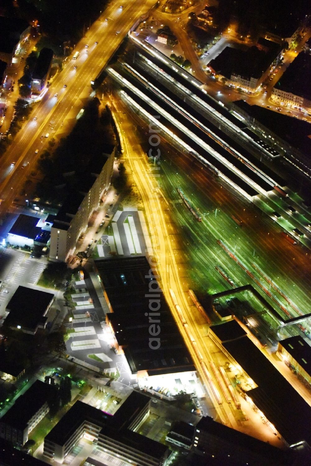 Aerial image at night Berlin - Night view building of the construction market of OBI Markt Berlin-Lichtenberg on Buchberger Str in Berlin