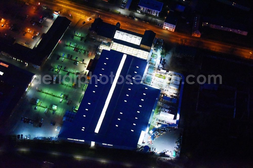 Lutherstadt Wittenberg at night from above - Night lighting Building of the construction market of OBI Markt Wittenberg on Dessauer Strasse in Lutherstadt Wittenberg in the state Saxony-Anhalt