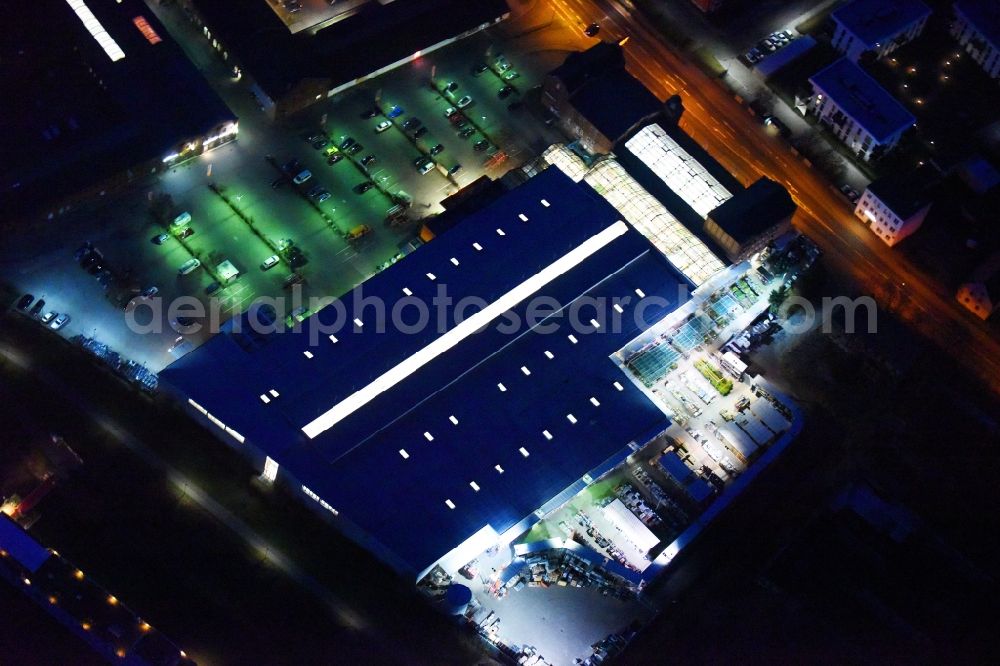 Aerial photograph at night Lutherstadt Wittenberg - Night lighting Building of the construction market of OBI Markt Wittenberg on Dessauer Strasse in Lutherstadt Wittenberg in the state Saxony-Anhalt