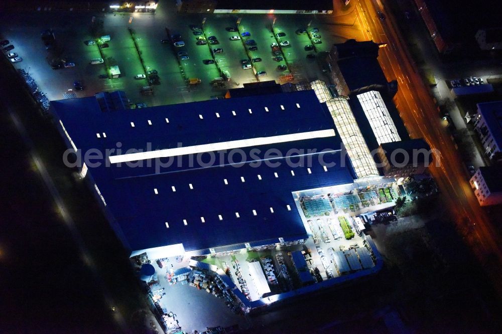 Lutherstadt Wittenberg at night from above - Night lighting Building of the construction market of OBI Markt Wittenberg on Dessauer Strasse in Lutherstadt Wittenberg in the state Saxony-Anhalt