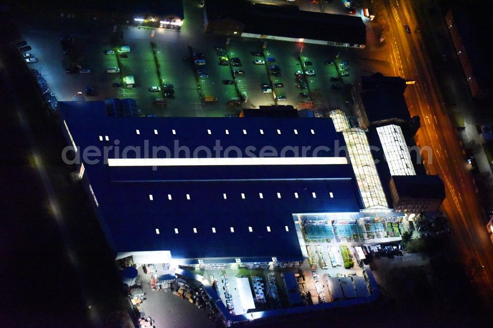 Lutherstadt Wittenberg at night from above - Night lighting Building of the construction market of OBI Markt Wittenberg on Dessauer Strasse in Lutherstadt Wittenberg in the state Saxony-Anhalt