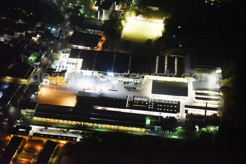 Aerial image at night Berlin - Night view building of the construction market of Possling GmbH & Co.KG Britz an der Haarlemer Strasse in Berlin