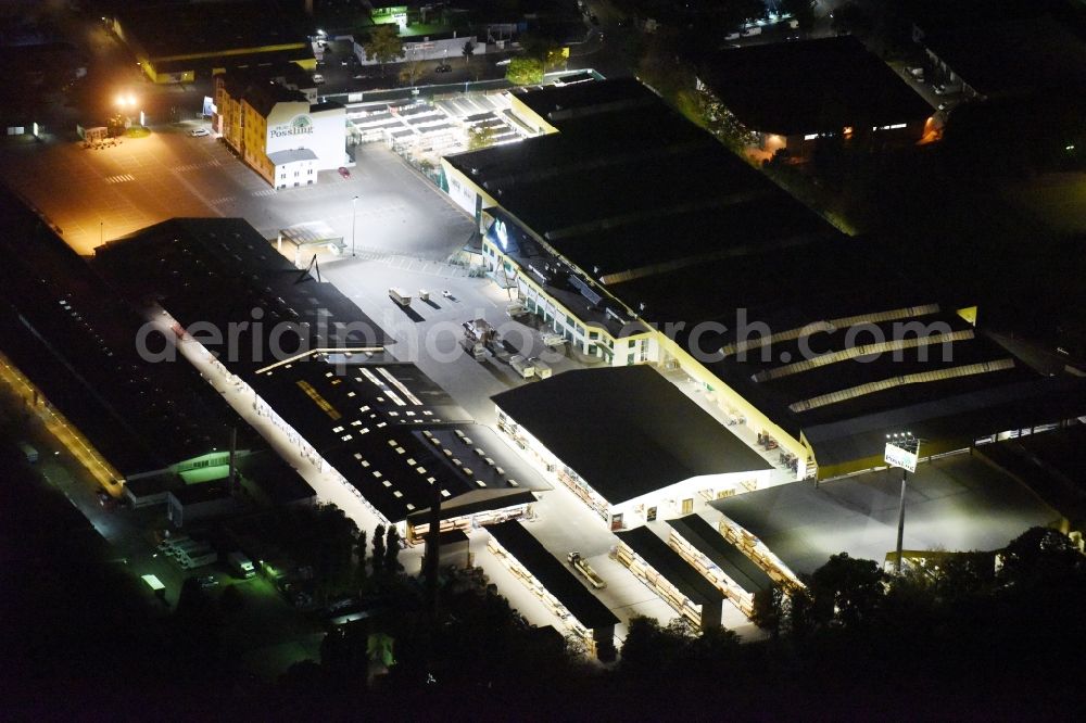 Berlin at night from the bird perspective: Night view building of the construction market of Possling GmbH & Co.KG Britz an der Haarlemer Strasse in Berlin