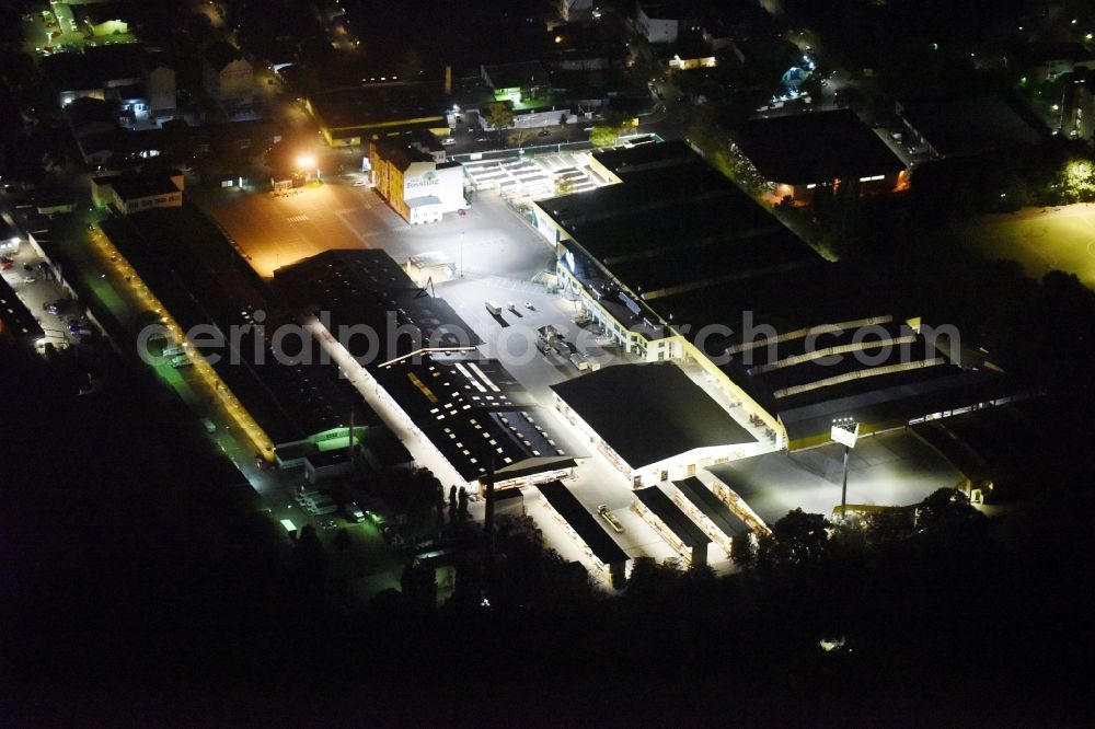 Aerial photograph at night Berlin - Night view building of the construction market of Possling GmbH & Co.KG Britz an der Haarlemer Strasse in Berlin