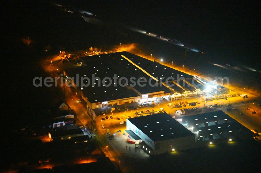 Fürstenwalde/Spree at night from above - Night lighting Building of the construction market toom on Alte Langewahler Chaussee in Fuerstenwalde/Spree in the state Brandenburg, Germany