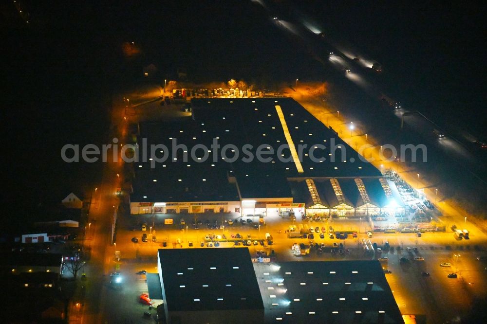 Aerial image at night Fürstenwalde/Spree - Night lighting Building of the construction market toom on Alte Langewahler Chaussee in Fuerstenwalde/Spree in the state Brandenburg, Germany