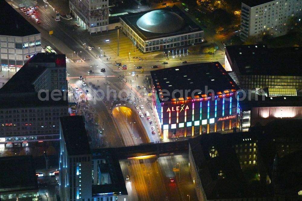 Aerial image at night Berlin - Night lighting Building of the shopping center Alexa on Grunerstrasse in Berlin, Germany