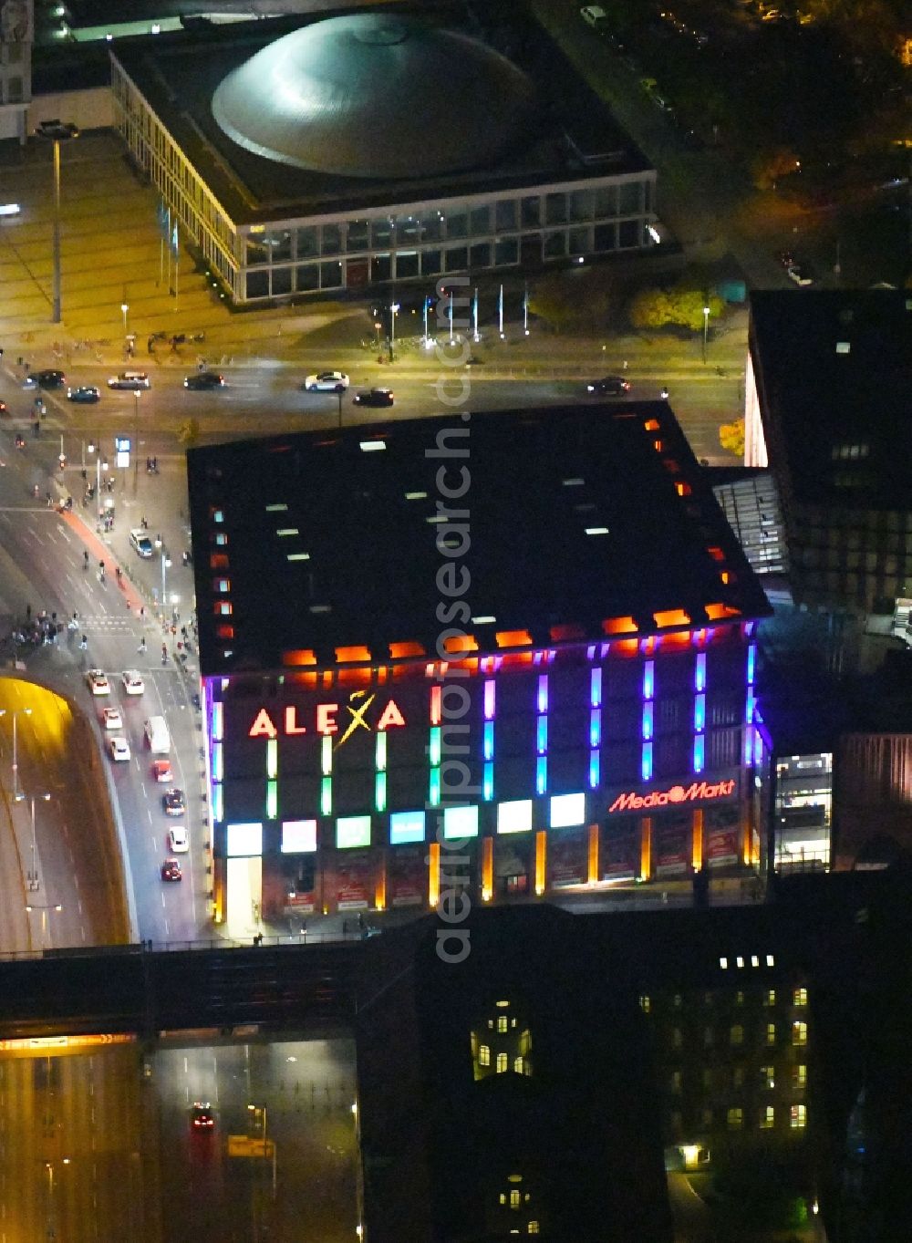 Berlin at night from the bird perspective: Night lighting Building of the shopping center Alexa on Grunerstrasse in Berlin, Germany