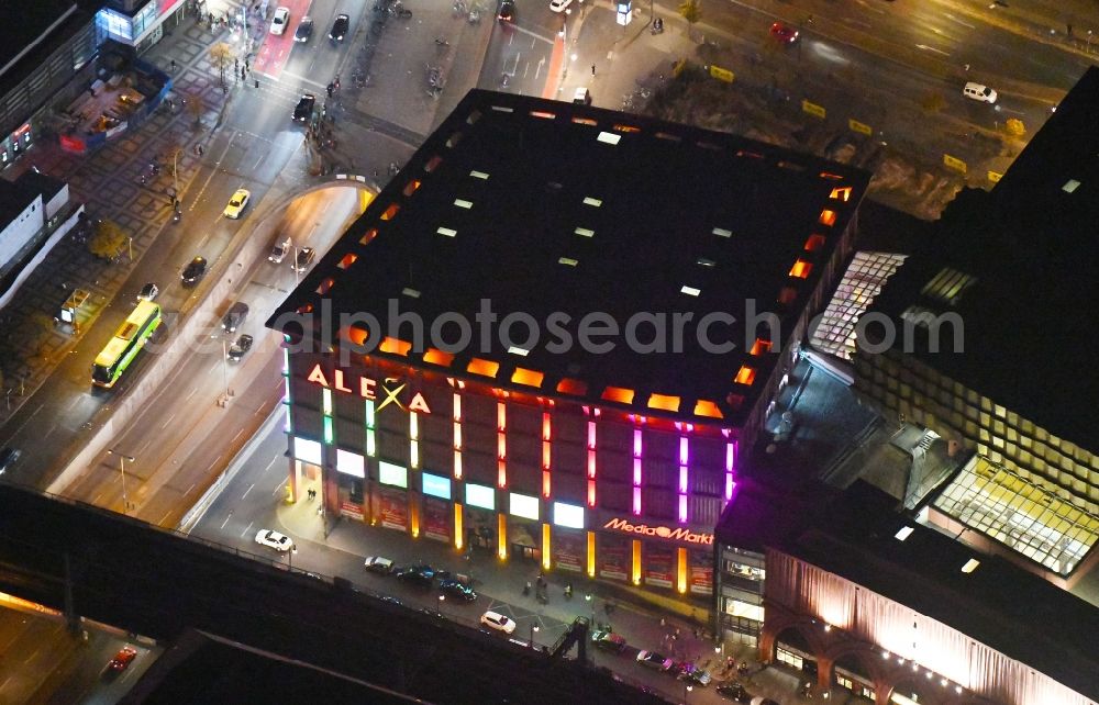 Aerial image at night Berlin - Night lighting Building of the shopping center Alexa on Grunerstrasse in Berlin, Germany