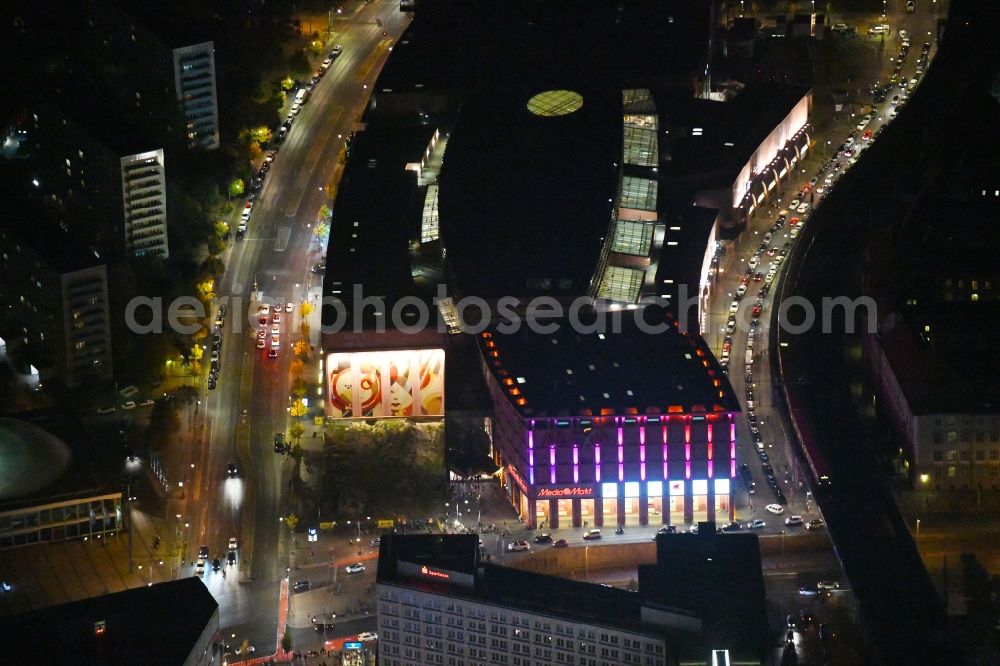 Aerial image at night Berlin - Night lighting Building of the shopping center Alexa on Grunerstrasse in Berlin, Germany