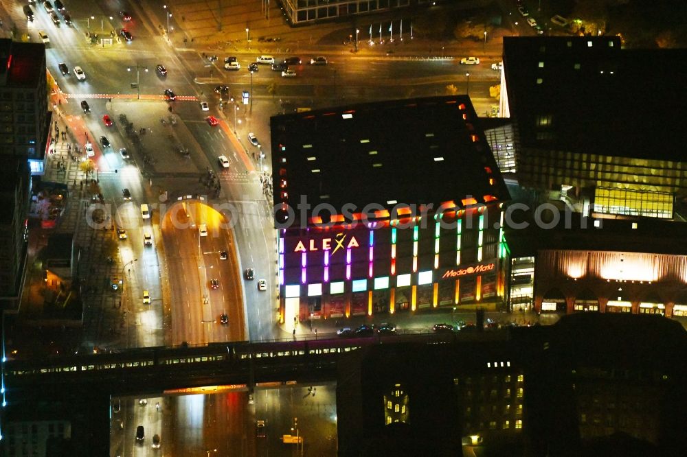 Berlin at night from the bird perspective: Night lighting Building of the shopping center Alexa on Grunerstrasse in Berlin, Germany