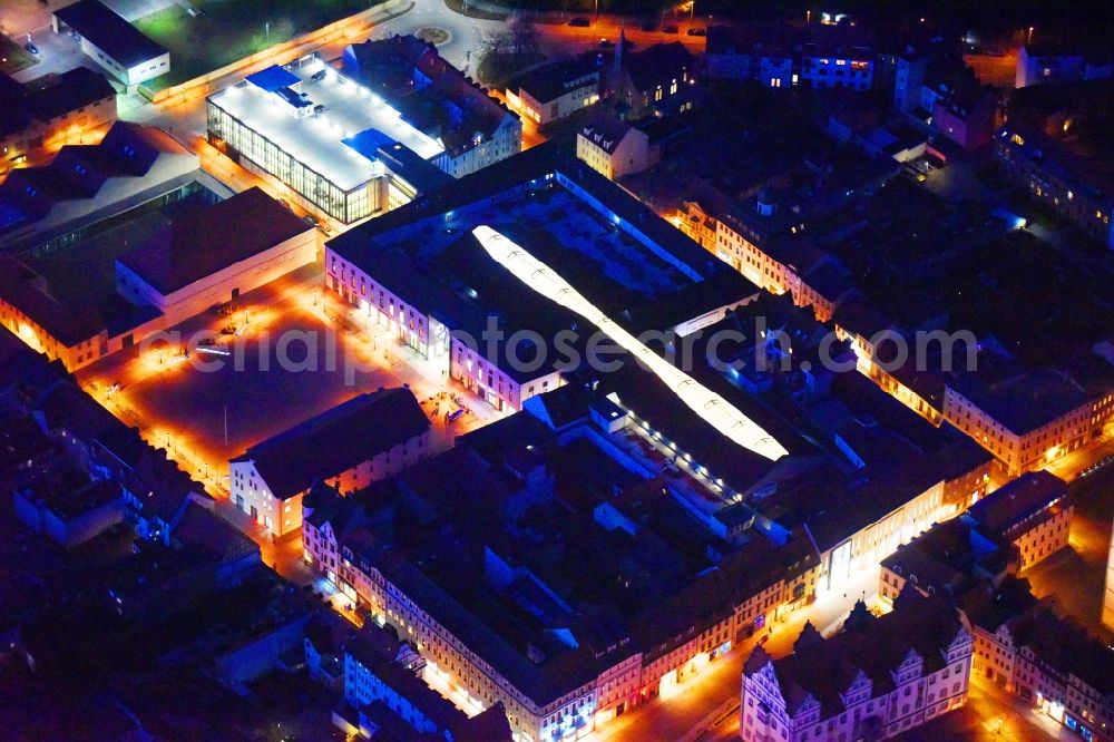 Lutherstadt Wittenberg at night from the bird perspective: Night lighting Building of the shopping center ARSENAL in Lutherstadt Wittenberg in the state Saxony-Anhalt