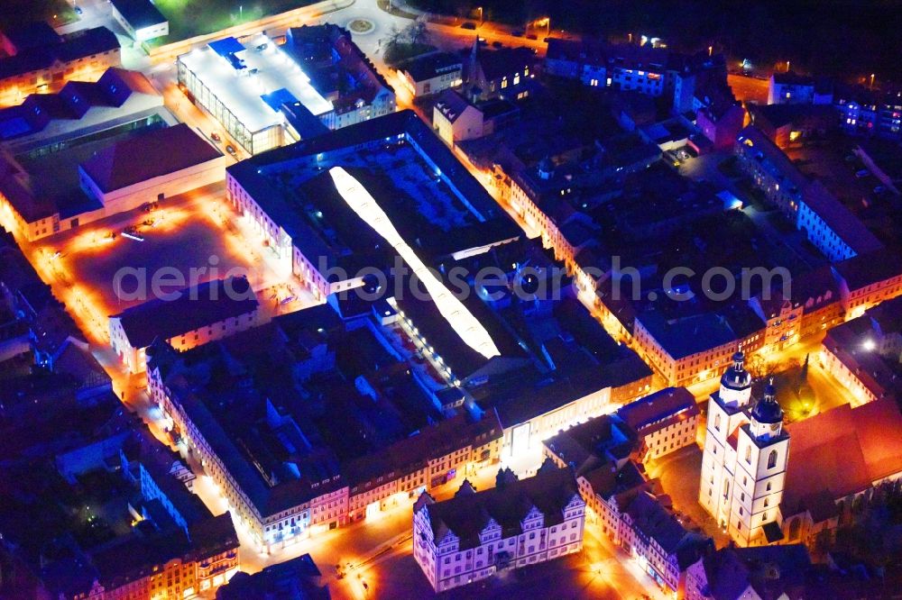 Aerial photograph at night Lutherstadt Wittenberg - Night lighting Building of the shopping center ARSENAL in Lutherstadt Wittenberg in the state Saxony-Anhalt