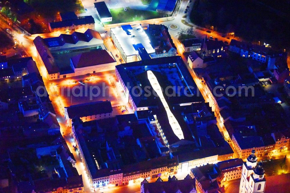 Aerial image at night Lutherstadt Wittenberg - Night lighting Building of the shopping center ARSENAL in Lutherstadt Wittenberg in the state Saxony-Anhalt