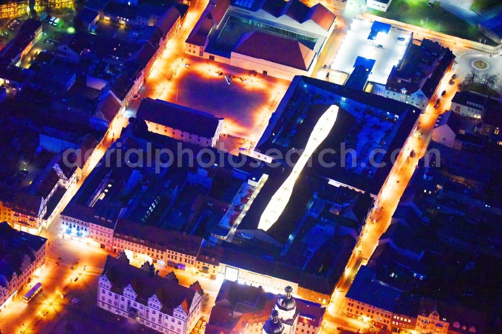 Aerial image at night Lutherstadt Wittenberg - Night lighting Building of the shopping center ARSENAL in Lutherstadt Wittenberg in the state Saxony-Anhalt