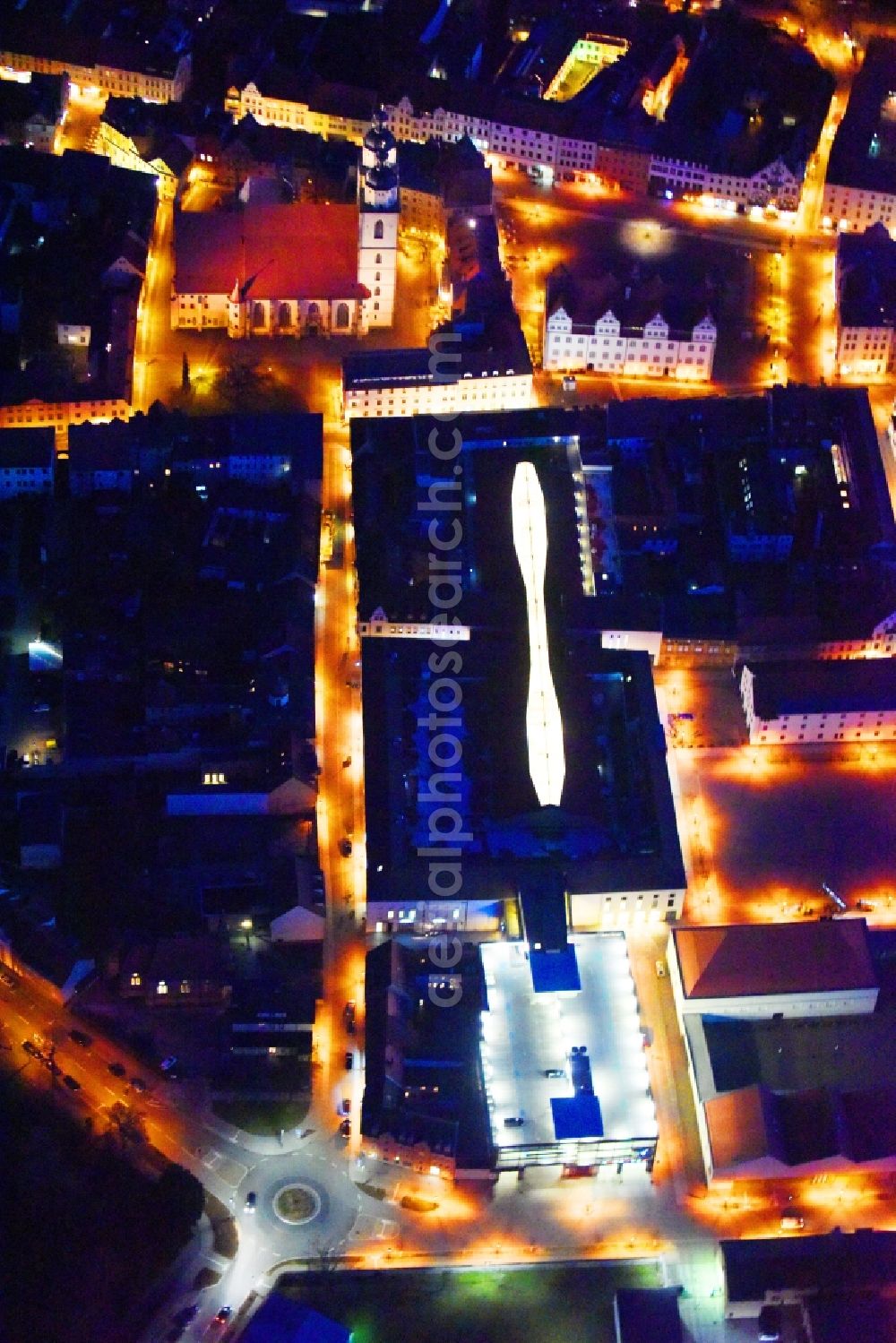 Aerial photograph at night Lutherstadt Wittenberg - Night lighting Building of the shopping center ARSENAL in Lutherstadt Wittenberg in the state Saxony-Anhalt