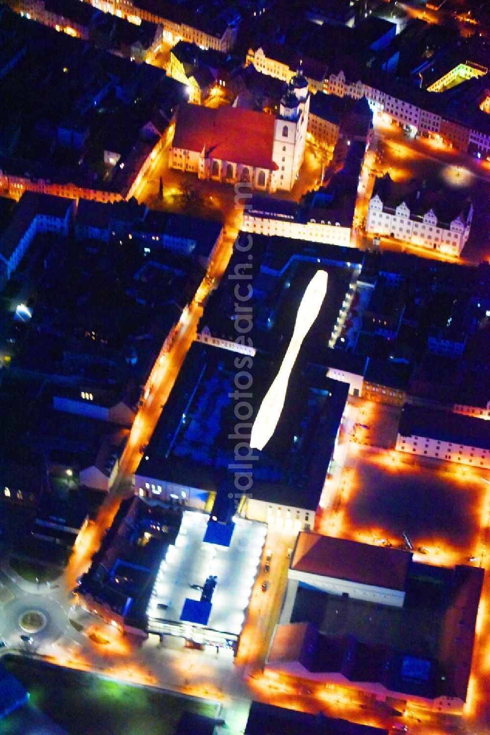 Aerial image at night Lutherstadt Wittenberg - Night lighting Building of the shopping center ARSENAL in Lutherstadt Wittenberg in the state Saxony-Anhalt