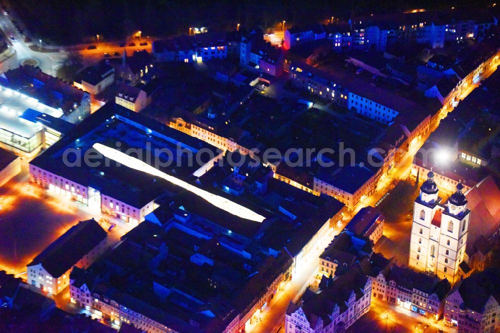 Aerial photograph at night Lutherstadt Wittenberg - Night lighting Building of the shopping center ARSENAL in Lutherstadt Wittenberg in the state Saxony-Anhalt