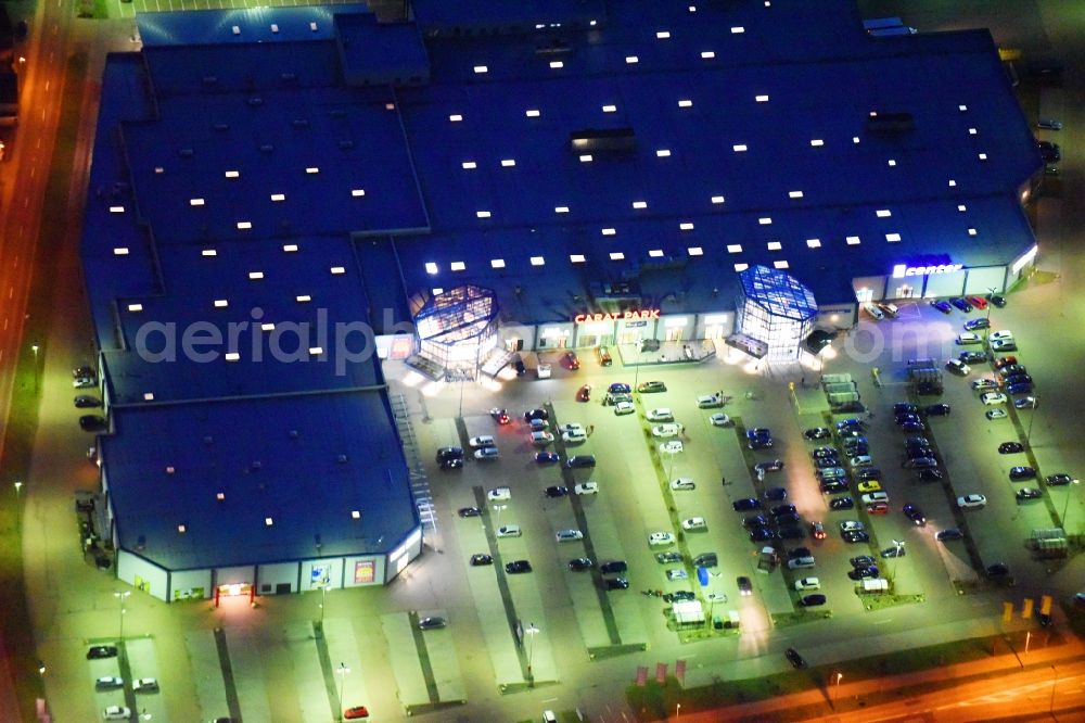 Aerial image at night Lutherstadt Wittenberg - Night lighting Building of the shopping center Carat-Park in Lutherstadt Wittenberg in the state Saxony-Anhalt