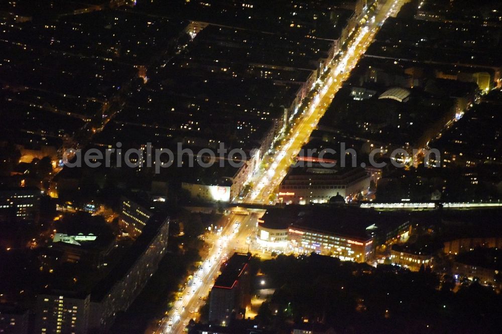 Aerial image at night Berlin - Night view building of the shopping center Ring-Center der ECE Gruppe an der Frankfurter Allee im Stadtbezirk Friedrichshain in Berlin