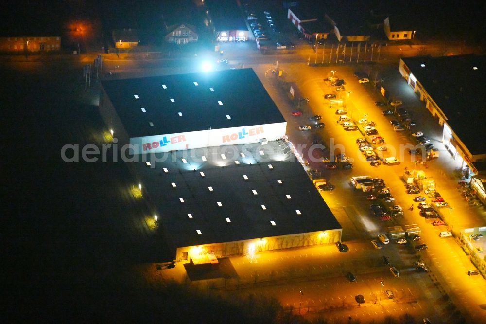 Aerial photograph at night Fürstenwalde/Spree - Night lighting Building of the store - furniture market Roller Moebel - Fuerstenwalde on Alte Langewahler Chaussee in Fuerstenwalde/Spree in the state Brandenburg, Germany