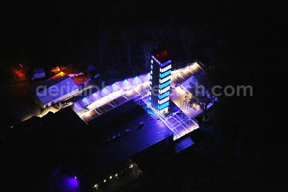 Aerial photograph at night Berlin - Night lighting Site of the tower- building ensemble of Mueggelturm in the forest Mueggelbergen Koepenick in Berlin