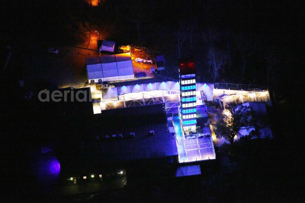 Berlin at night from above - Night lighting Site of the tower- building ensemble of Mueggelturm in the forest Mueggelbergen Koepenick in Berlin