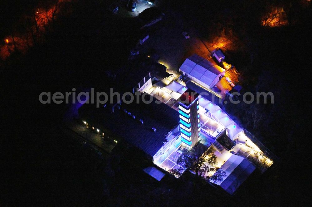 Berlin at night from the bird perspective: Night lighting Site of the tower- building ensemble of Mueggelturm in the forest Mueggelbergen Koepenick in Berlin