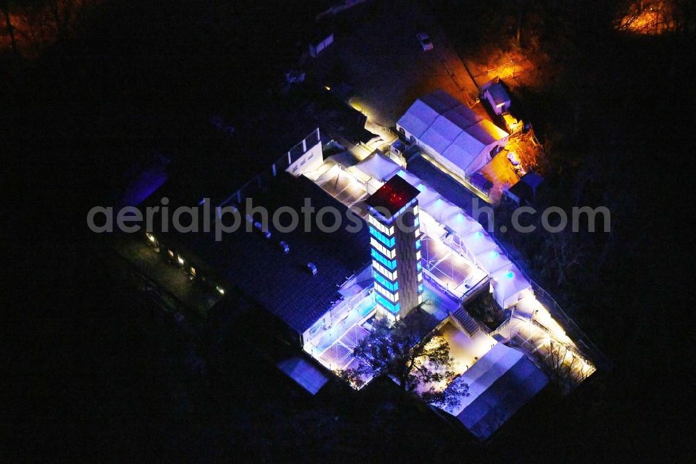 Aerial photograph at night Berlin - Night lighting Site of the tower- building ensemble of Mueggelturm in the forest Mueggelbergen Koepenick in Berlin