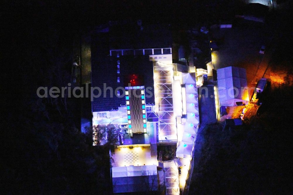 Aerial image at night Berlin - Night lighting Site of the tower- building ensemble of Mueggelturm in the forest Mueggelbergen Koepenick in Berlin