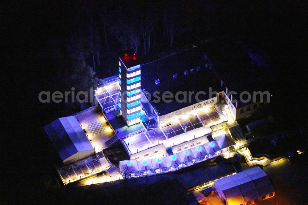 Aerial photograph at night Berlin - Night lighting Site of the tower- building ensemble of Mueggelturm in the forest Mueggelbergen Koepenick in Berlin