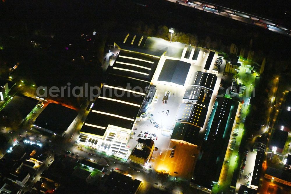 Aerial image at night Berlin - Night lighting Building of the construction market Holz Possling on Haarlemer Strasse in the district Neukoelln in Berlin, Germany